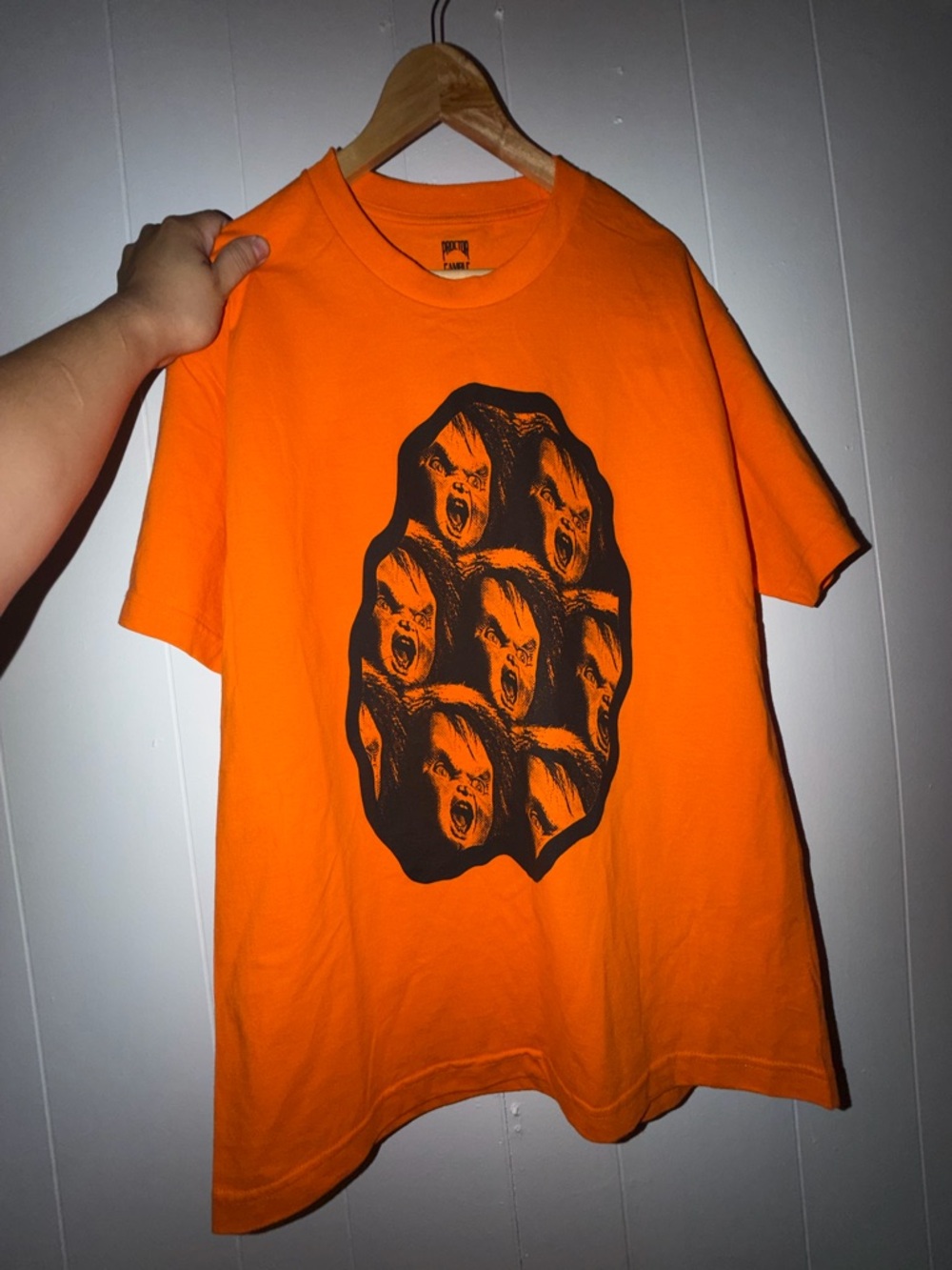 Graphic Orange Short Sleeve Tee with Black Multi-Face Print